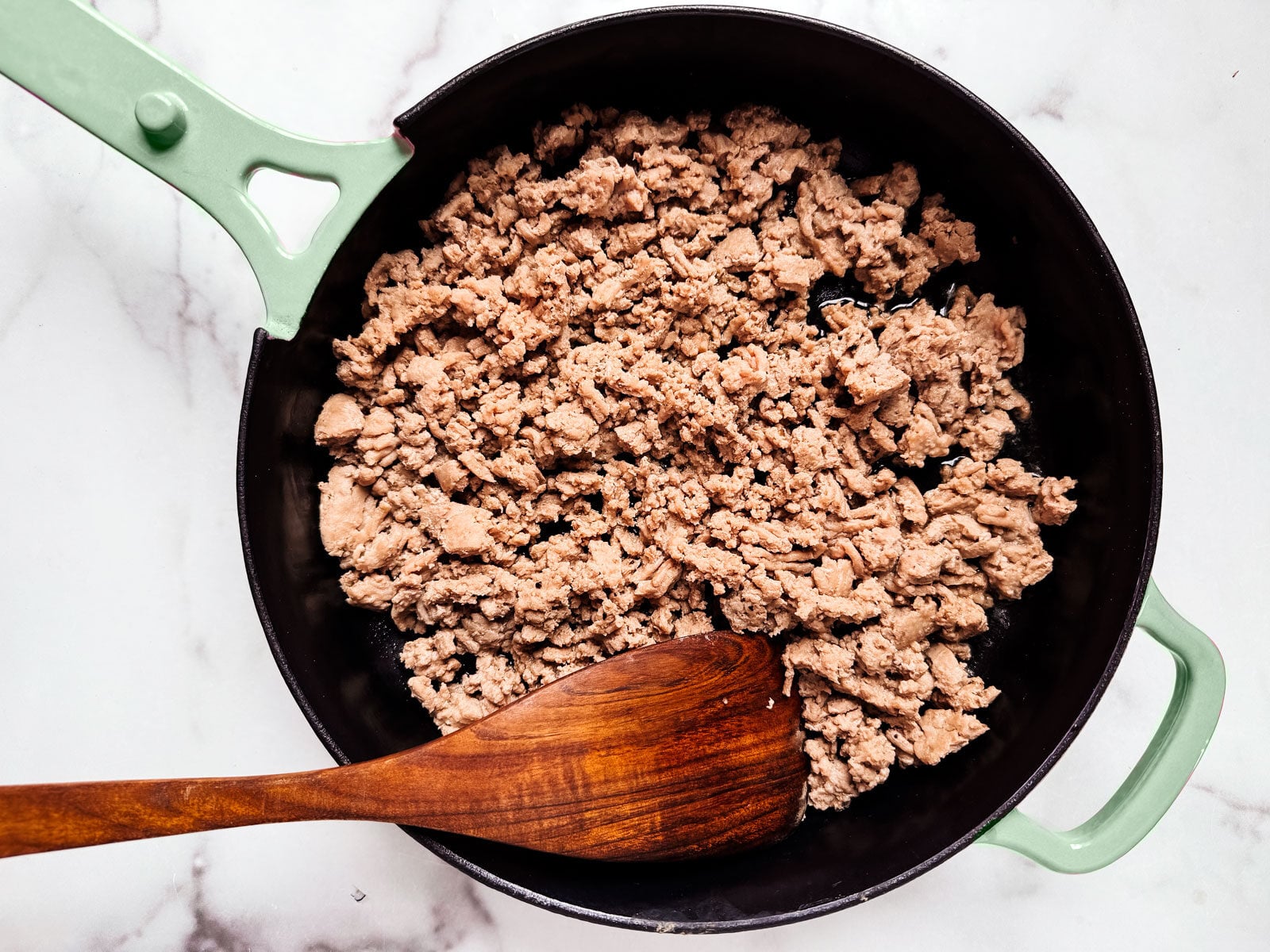 Ground turkey, cooked, in a skillet.