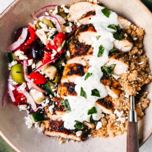 Greek quinoa bowl with chicken drizzle with tzatziki.