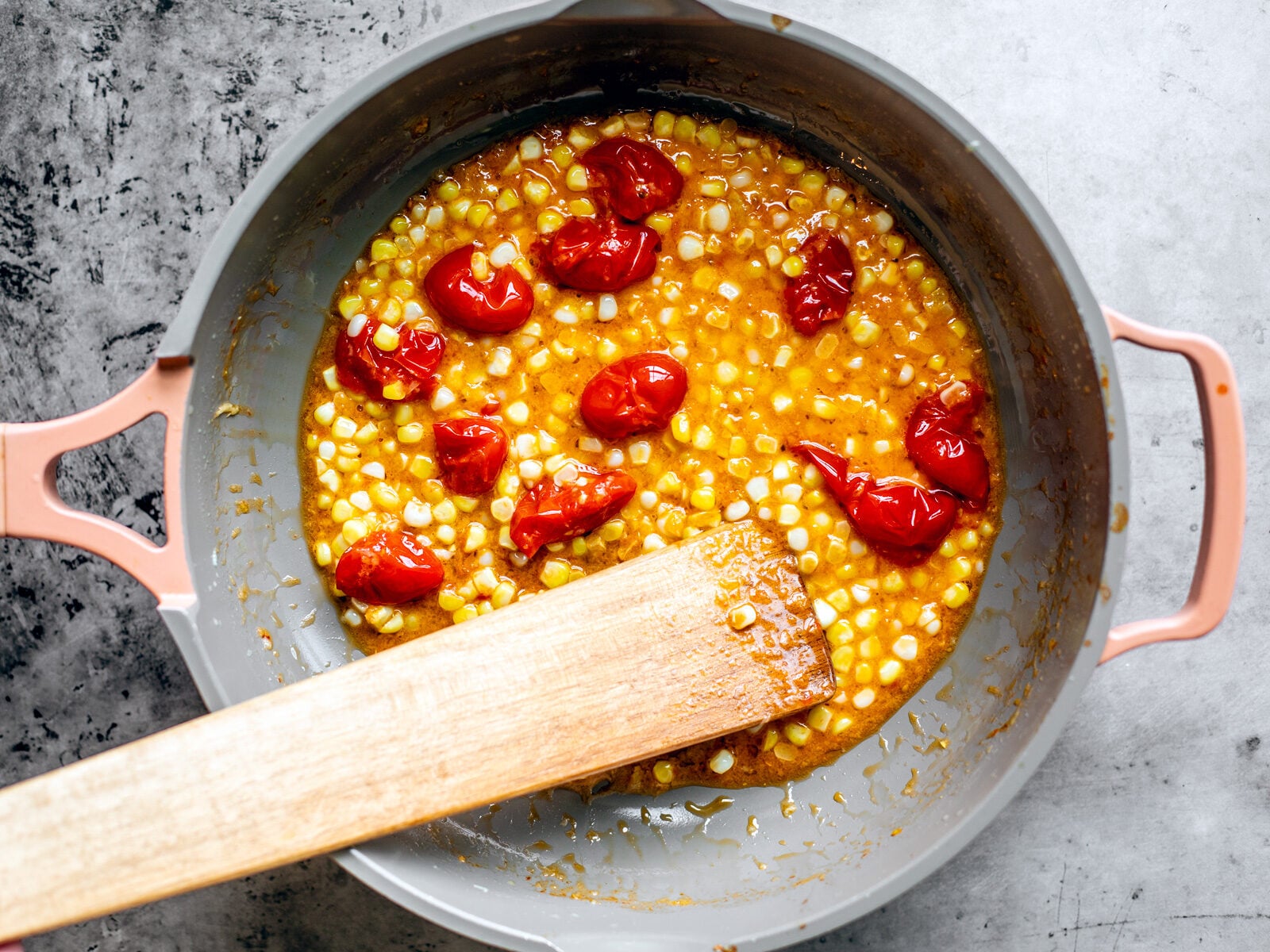 Pan with tomatoes and corn in a butter wine sauce.